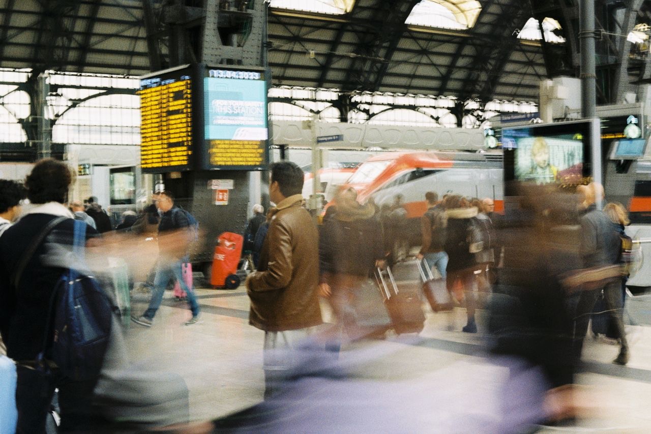 Travelers moving through an international station